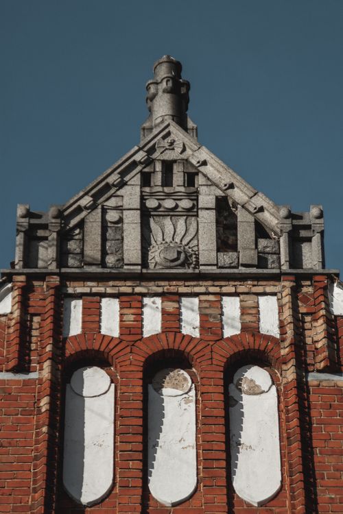 Free Detailed view of historic brick building facade in Vyborg, Russia, showcasing intricate architectural designs. Stock Photo