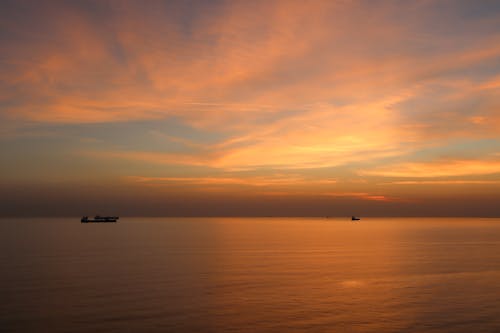 Silhouette of Boats on Sea during Dawn