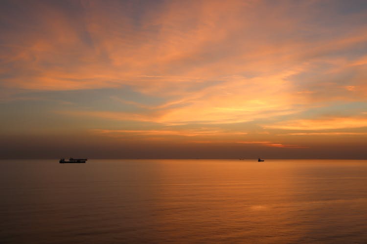 Silhouette Of Boats On Sea During Dawn