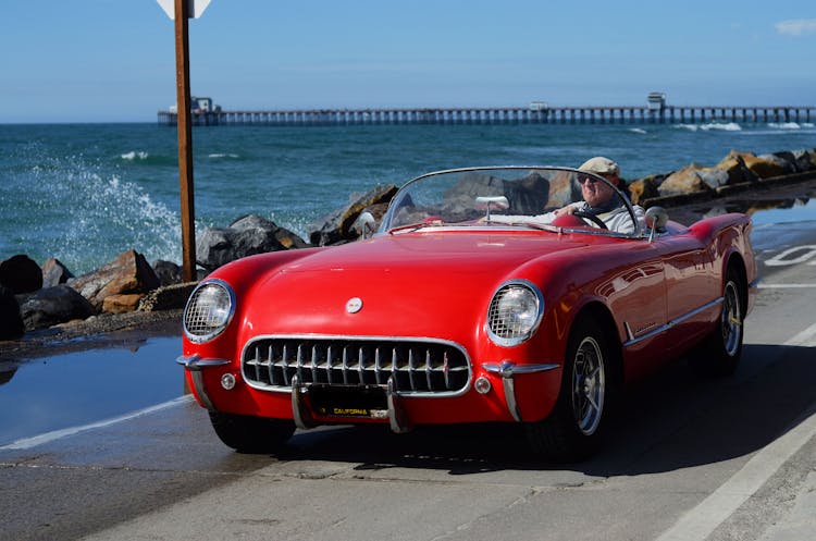 Man Driving A Red Car