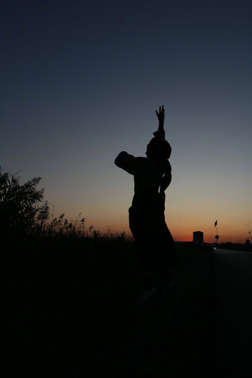 Silhouette of female in countryside at night