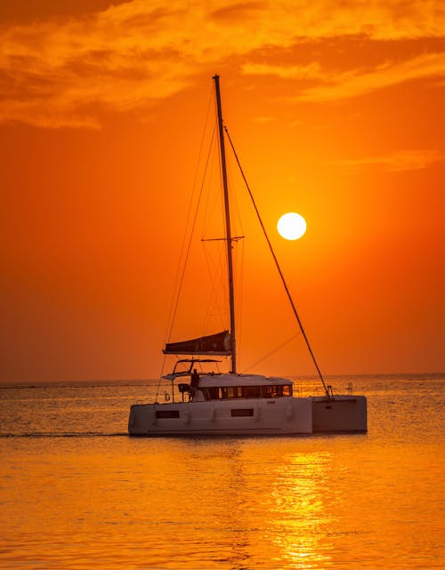 Boat sailing in sunset