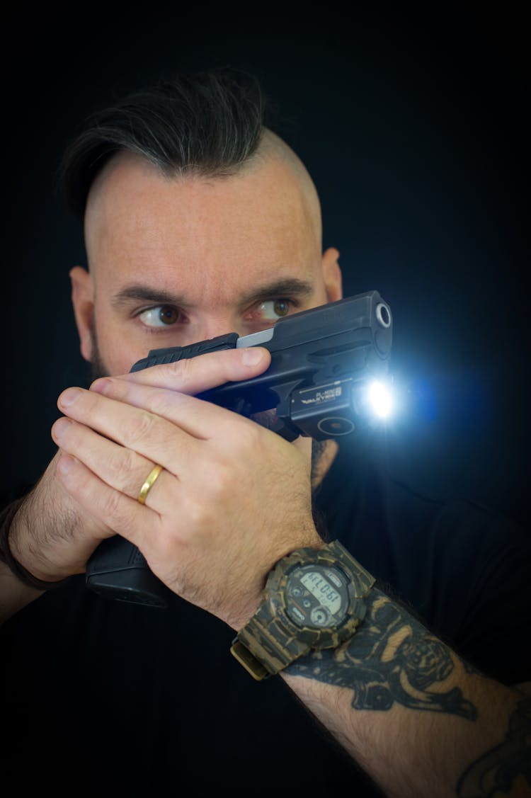 Close-Up Shot Of A Man Holding A TASER Gun