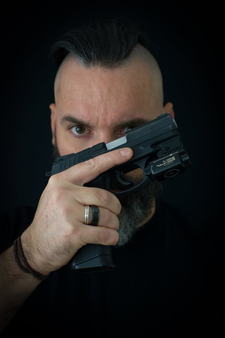 Close-Up Shot Of A Man Holding A TASER Gun