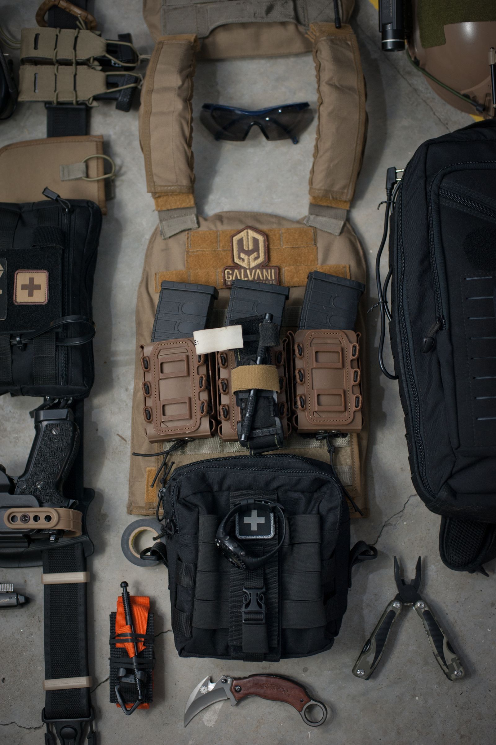 Organized outdoor packs, tools, and equipment prepared for storage