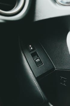Detailed view of a car's auto lock button on a modern vehicle interior.