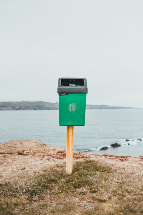 Free Green Trash Can on the Shore Stock Photo