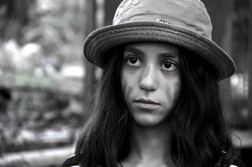 Grayscale Photo of a Woman with a Hat