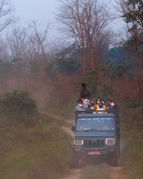 Free Group enjoying an off-road safari ride through the dusty trails of Subarnapur, Nepal. Stock Photo