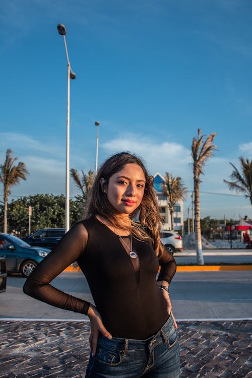 A Pretty Woman in Black Top Posing Outside