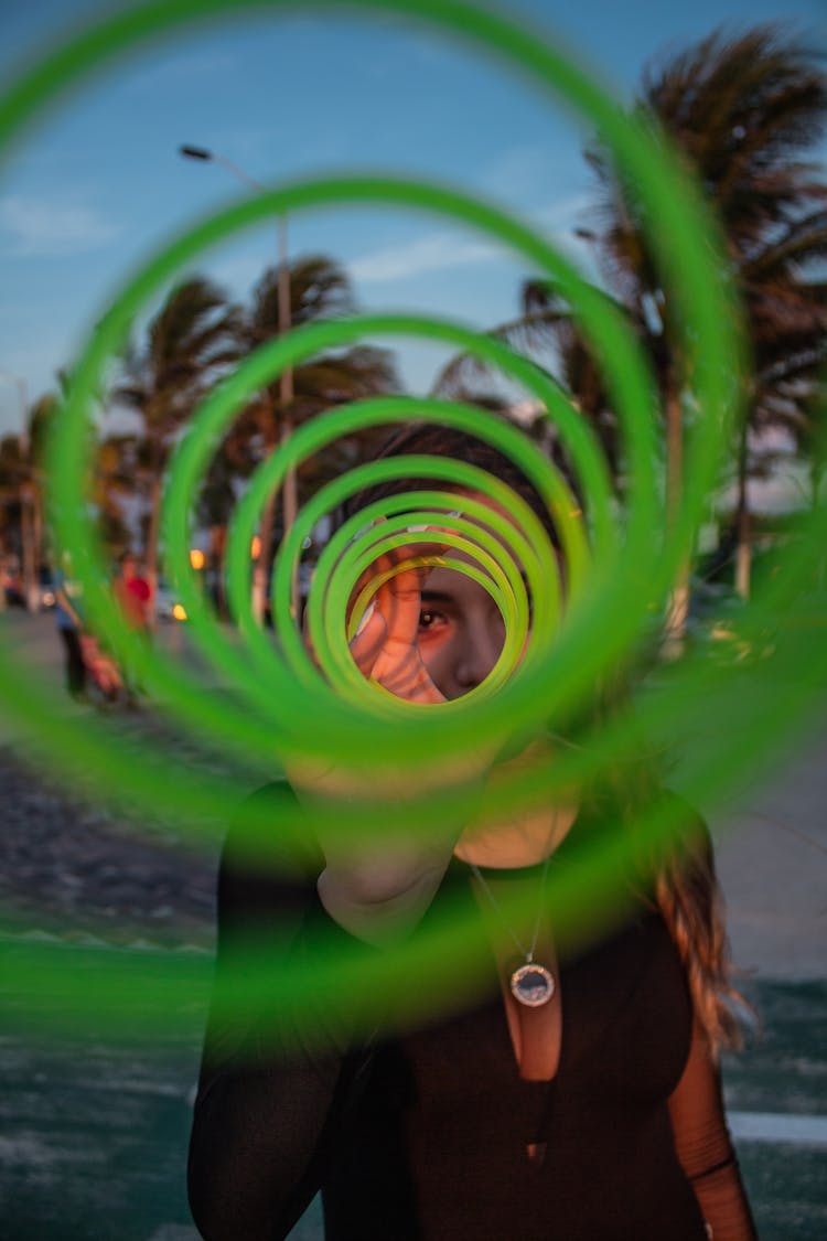 Woman Looking Through A Stretched Out Bouncy Spring Toy 