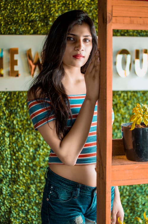 Beautiful Woman in a Blue and Red Crop Top Looking at the Camera