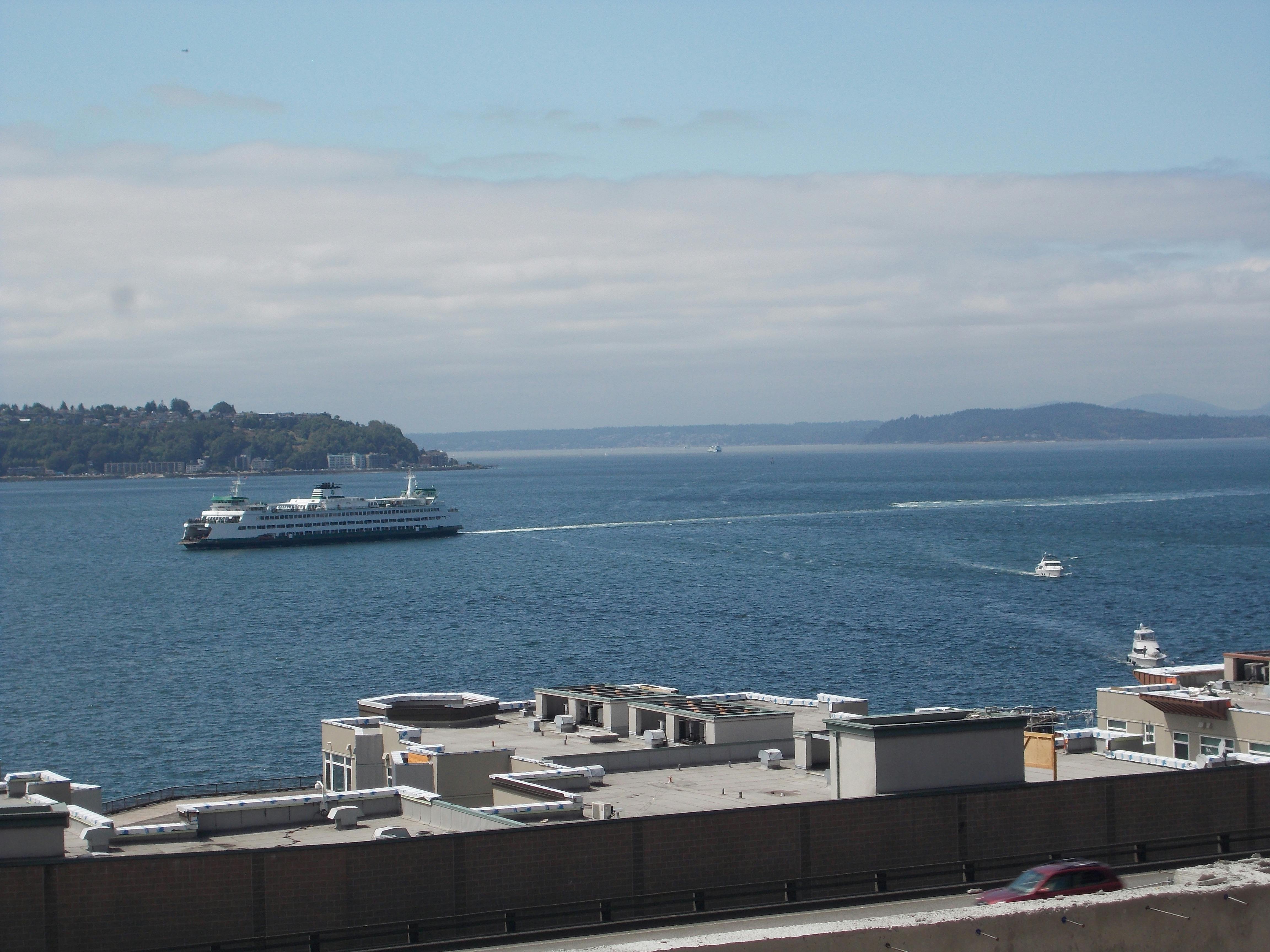 Winter athlete on a podium holding a medal in front of a snowy backdrop