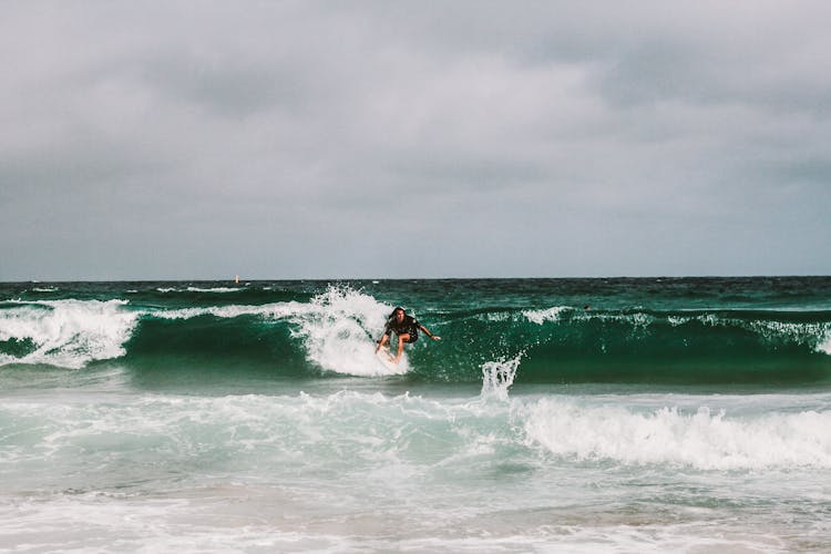 Man Surfing On Ocean Waves