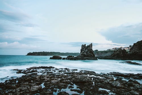 Photo Of Seashore With Rocks During Daylight