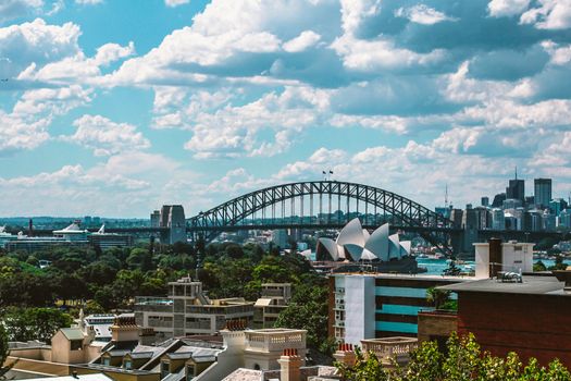 Stunning view of Sydney Harbour Bridge and Sydney Opera House on a sunny day, showcasing the vibrant cityscape.