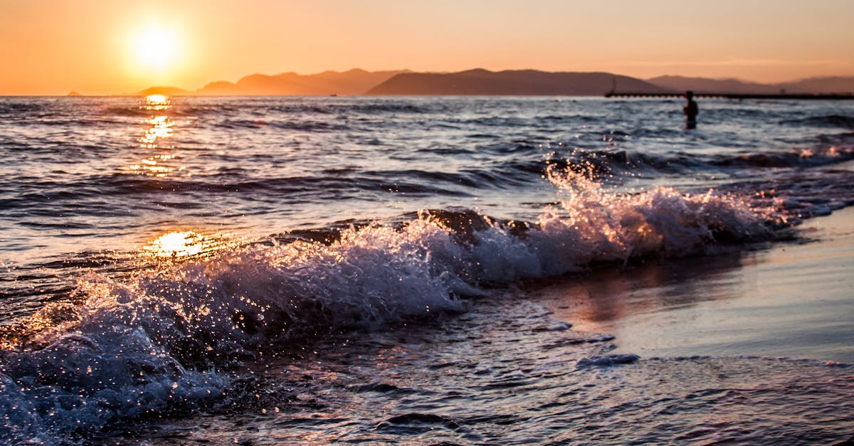 Vibrant sunset over the waves in Lazio, Italy. Perfect seascape with golden reflections.