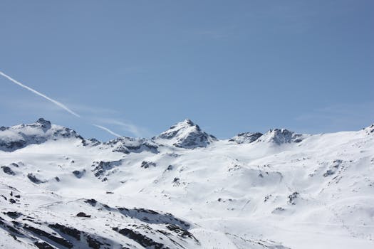 Spectacular view of snow-covered mountains and clear blue sky, perfect for winter enthusiasts.