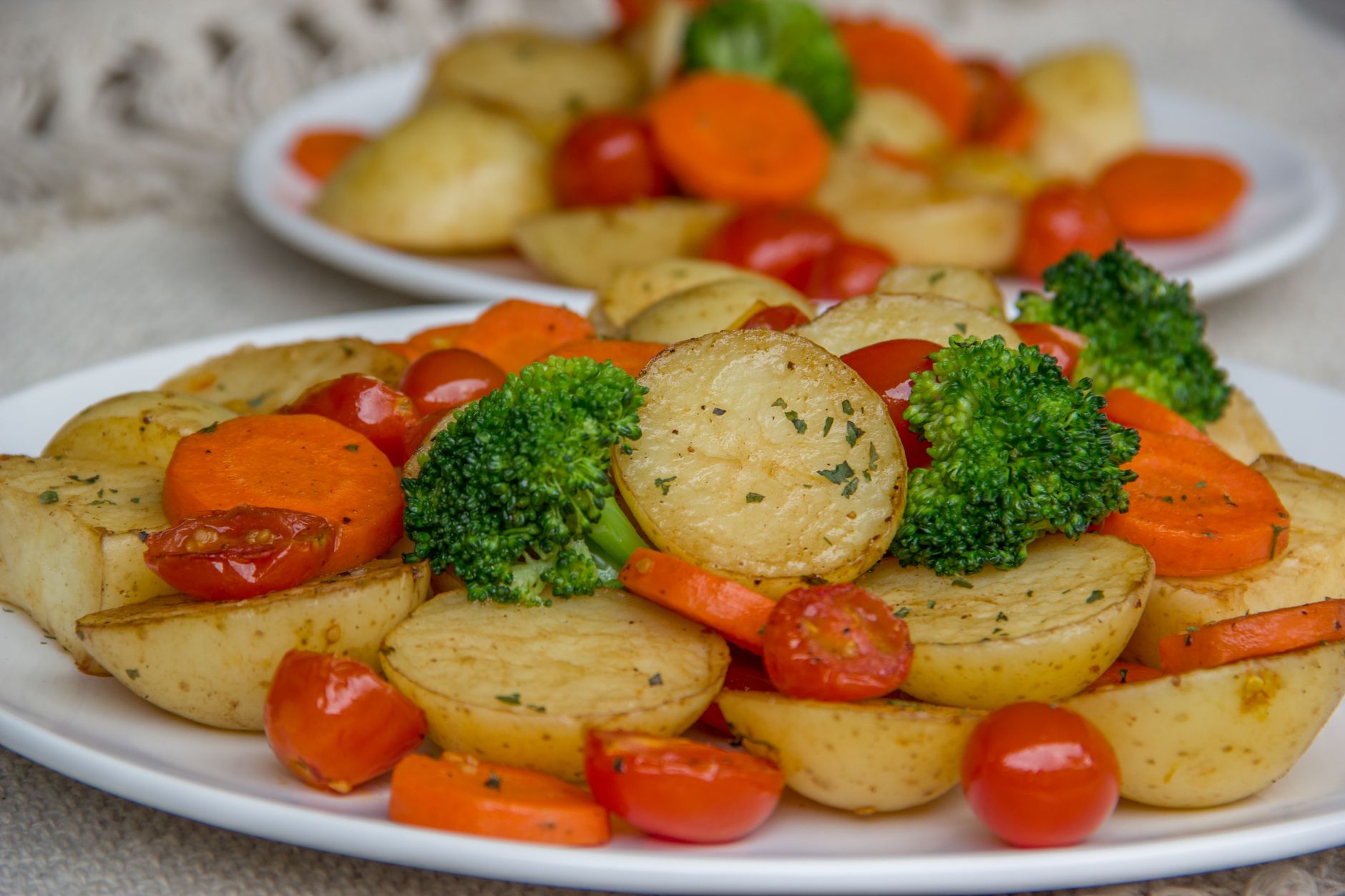 Sliced roast beef served with roasted potatoes and carrots