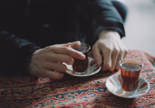 Person Holding a Cup of Tea