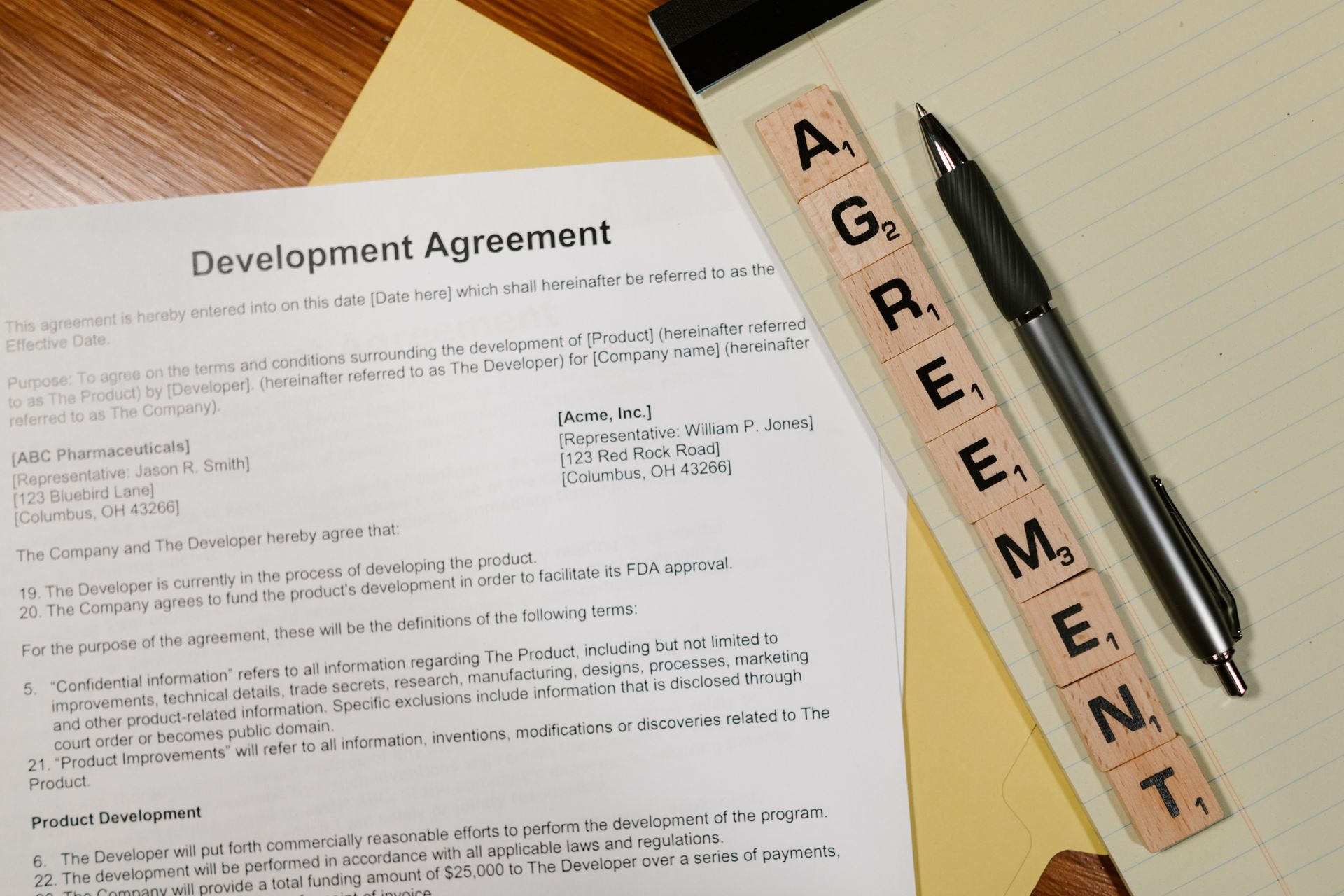 Close-Up Shot of Documents beside a Pen