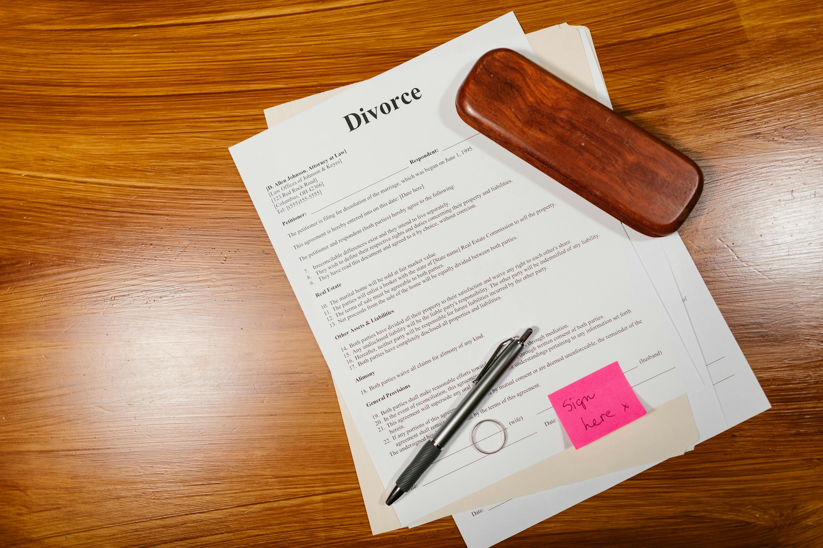 A Divorce Paper with Pen on a Wooden Floor