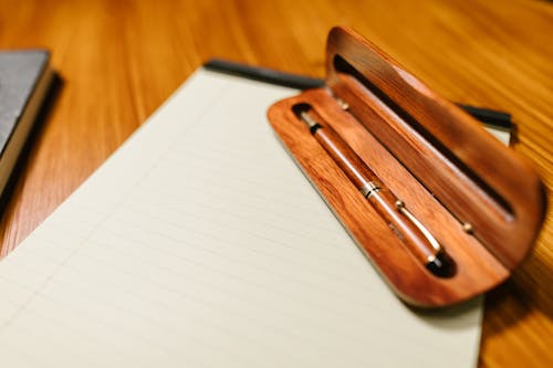 Free Brown Pen on White Paper Stock Photo