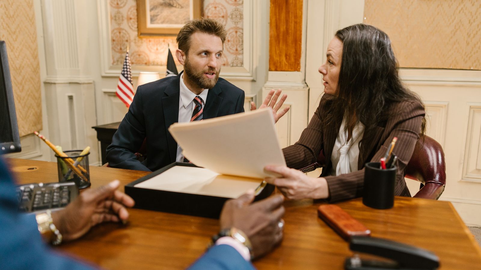 A lawyer and clients working through options together across the table.