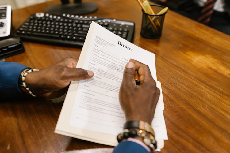 Close-Up Shot Of A Person Holding Divorce Papers