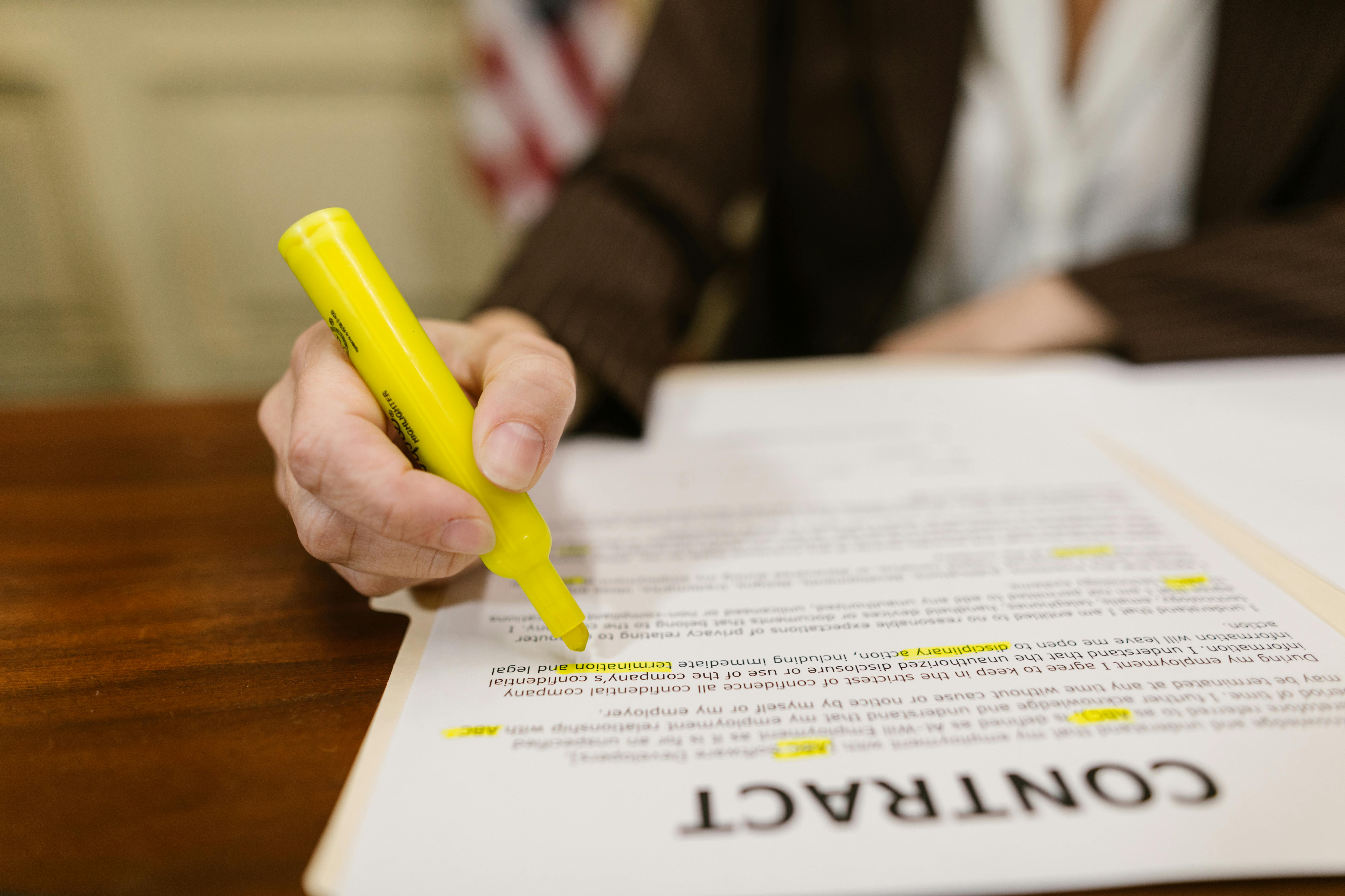 Free Close-Up Shot of a Person Writing on a Contract Stock Photo