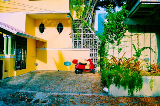 Vibrant urban street scene in San Juan featuring a red scooter against a colorful house facade.
