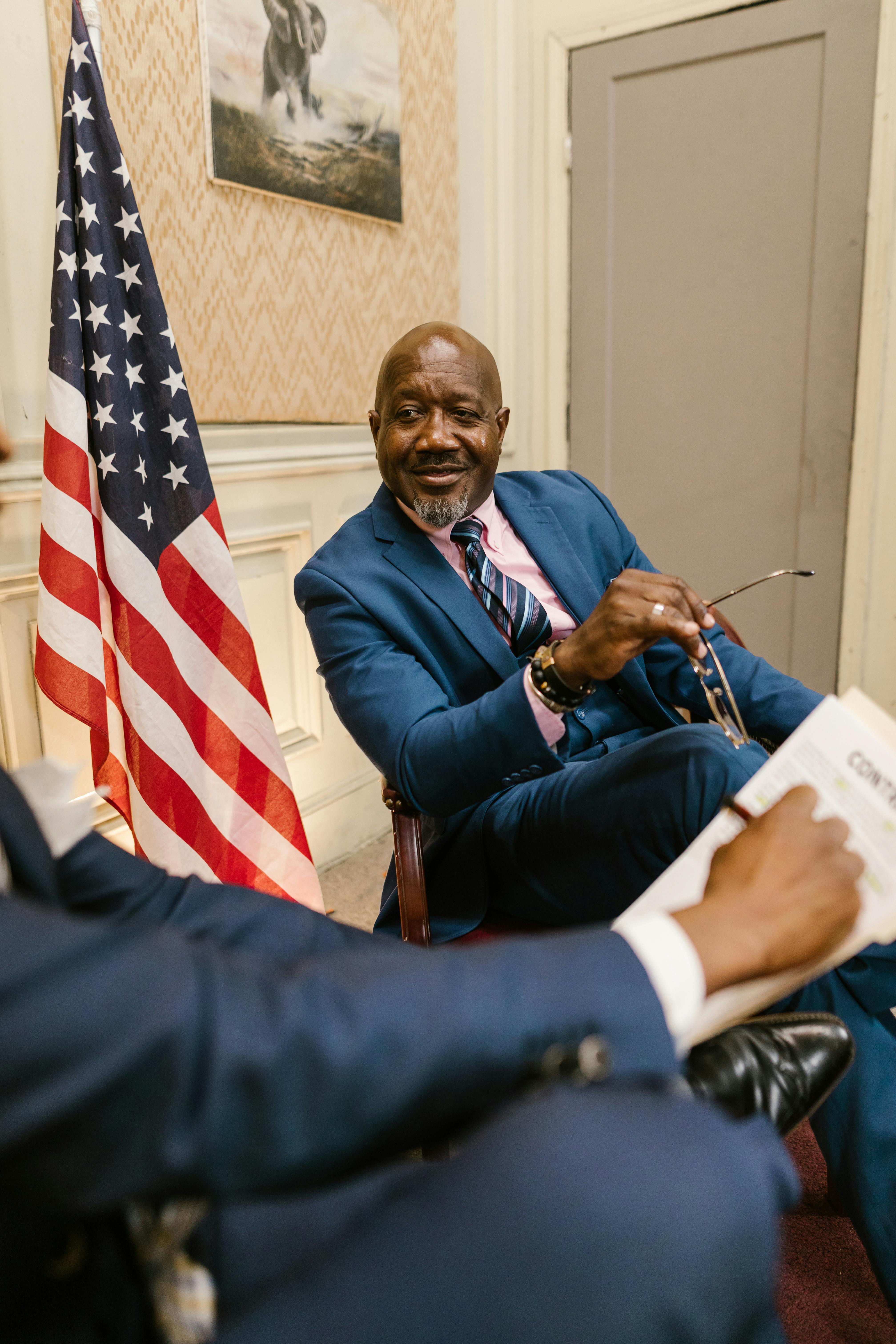 man in blue suit jacket sitting beside man in blue suit