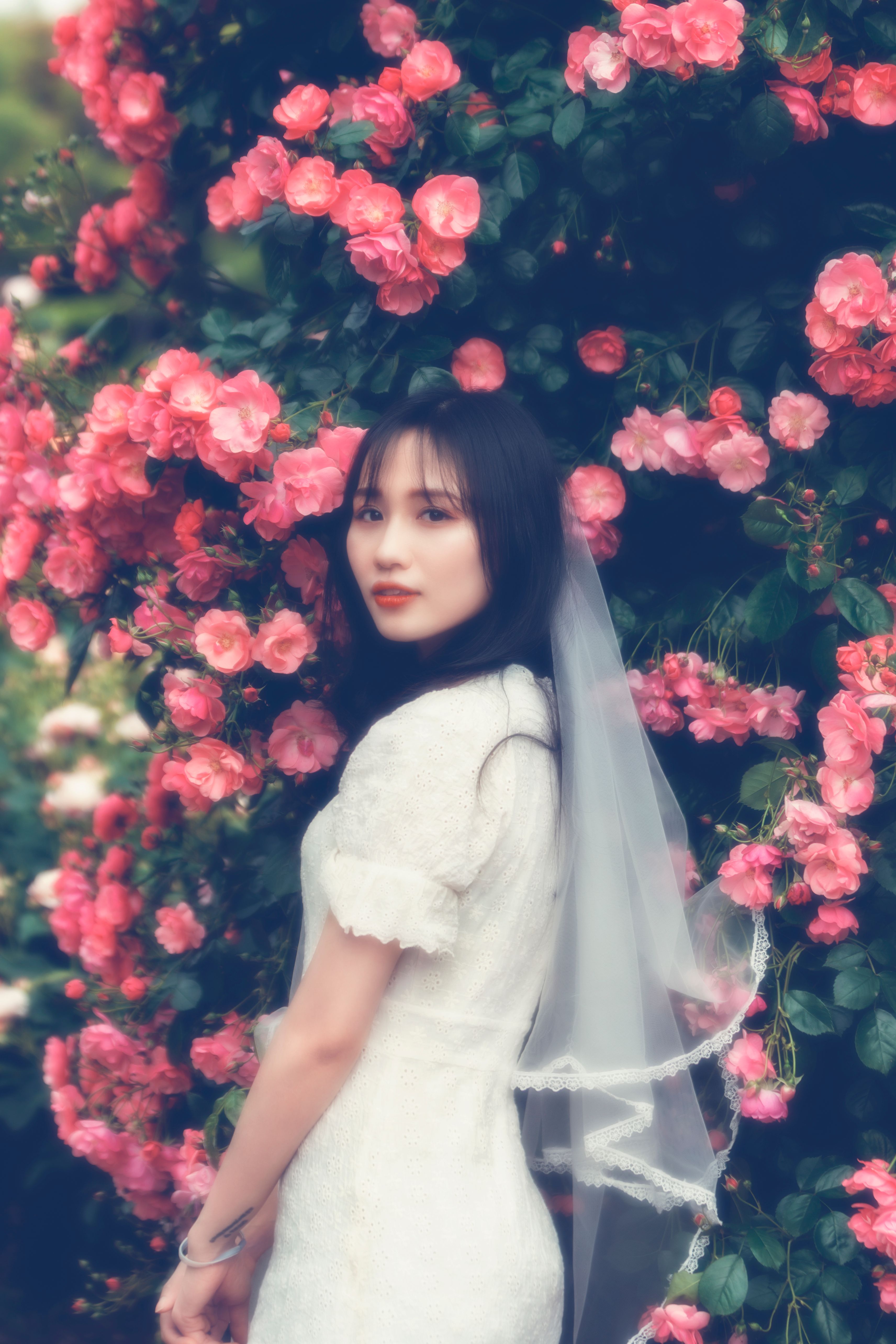 Woman in a Pink Dress Holding Flowers · Free Stock Photo