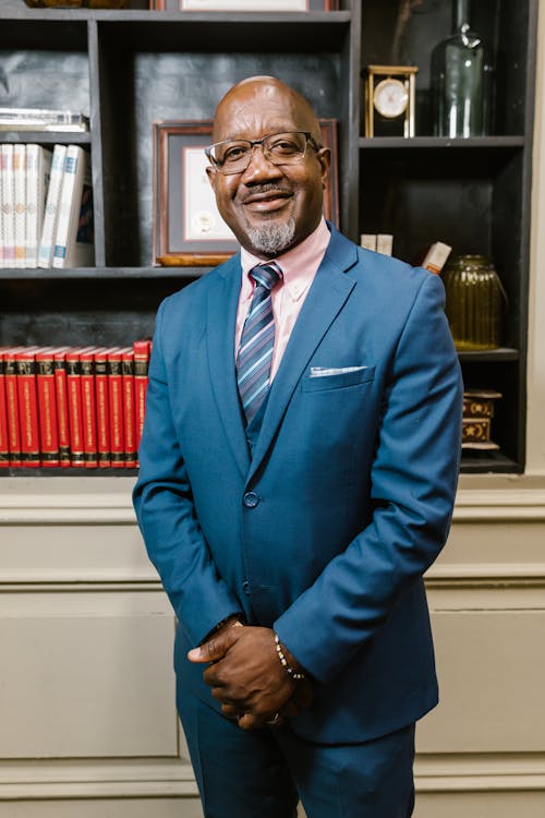 Man Wearing Blue Suit and Eyeglasses