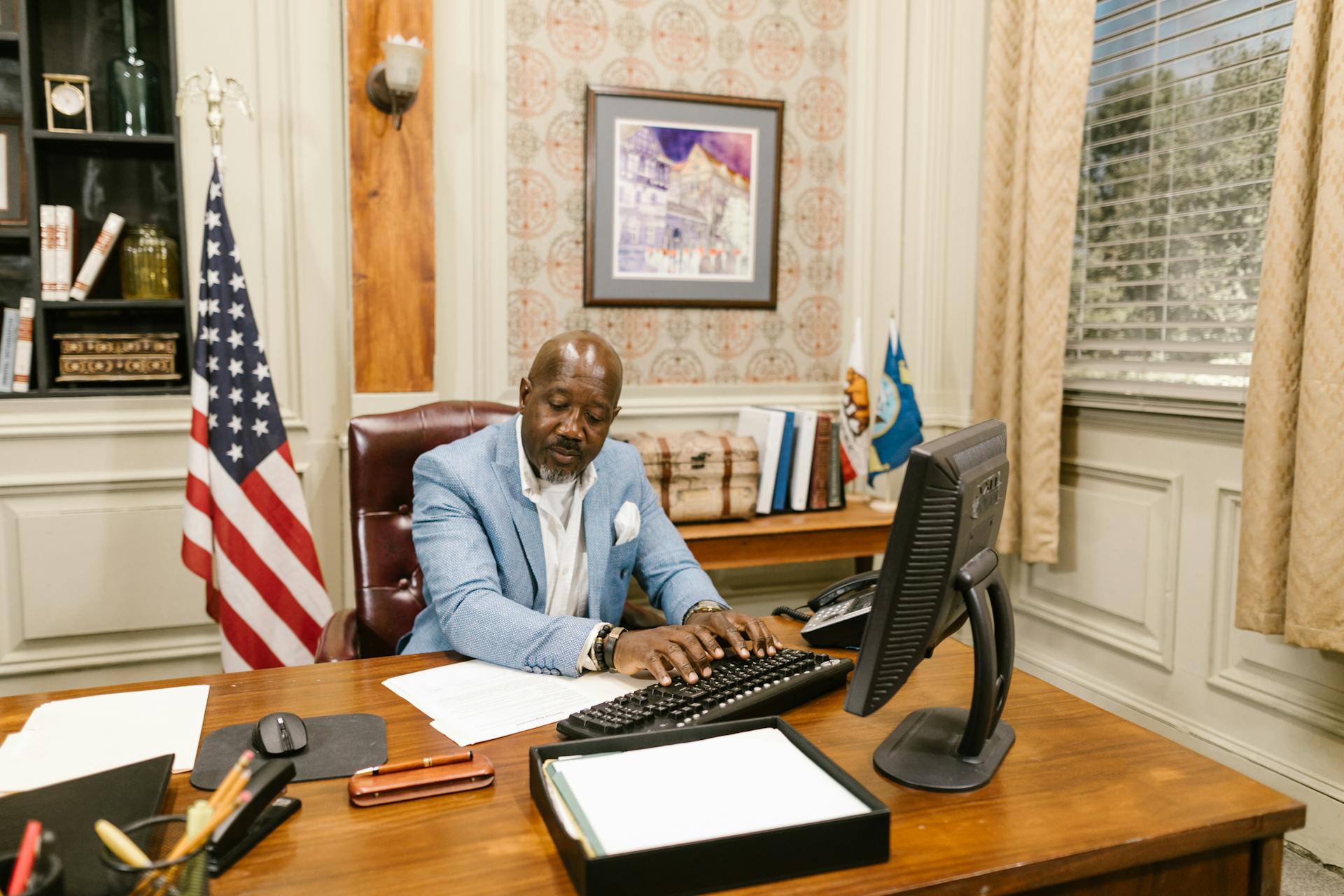 An Attorney in Blue Suit Using a Computer