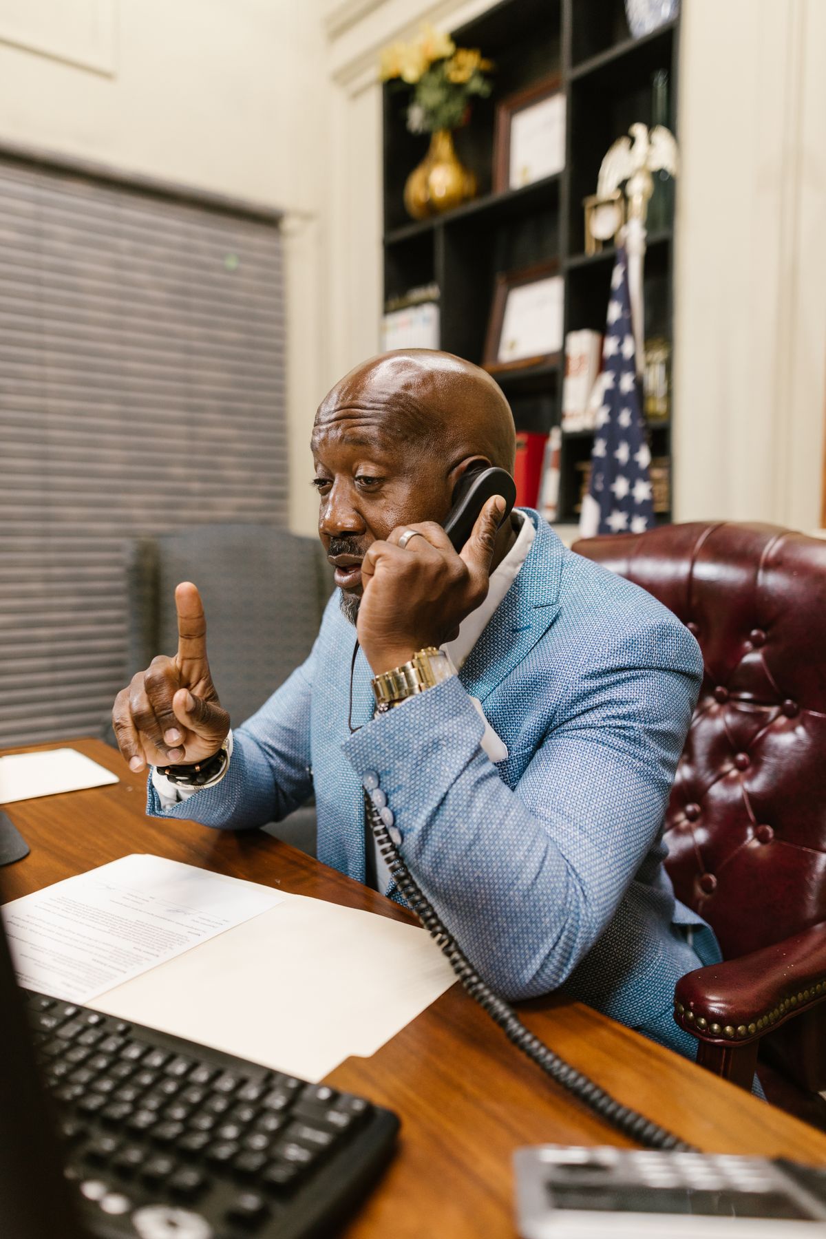 An Apex Audit consultant on a client call at his desk