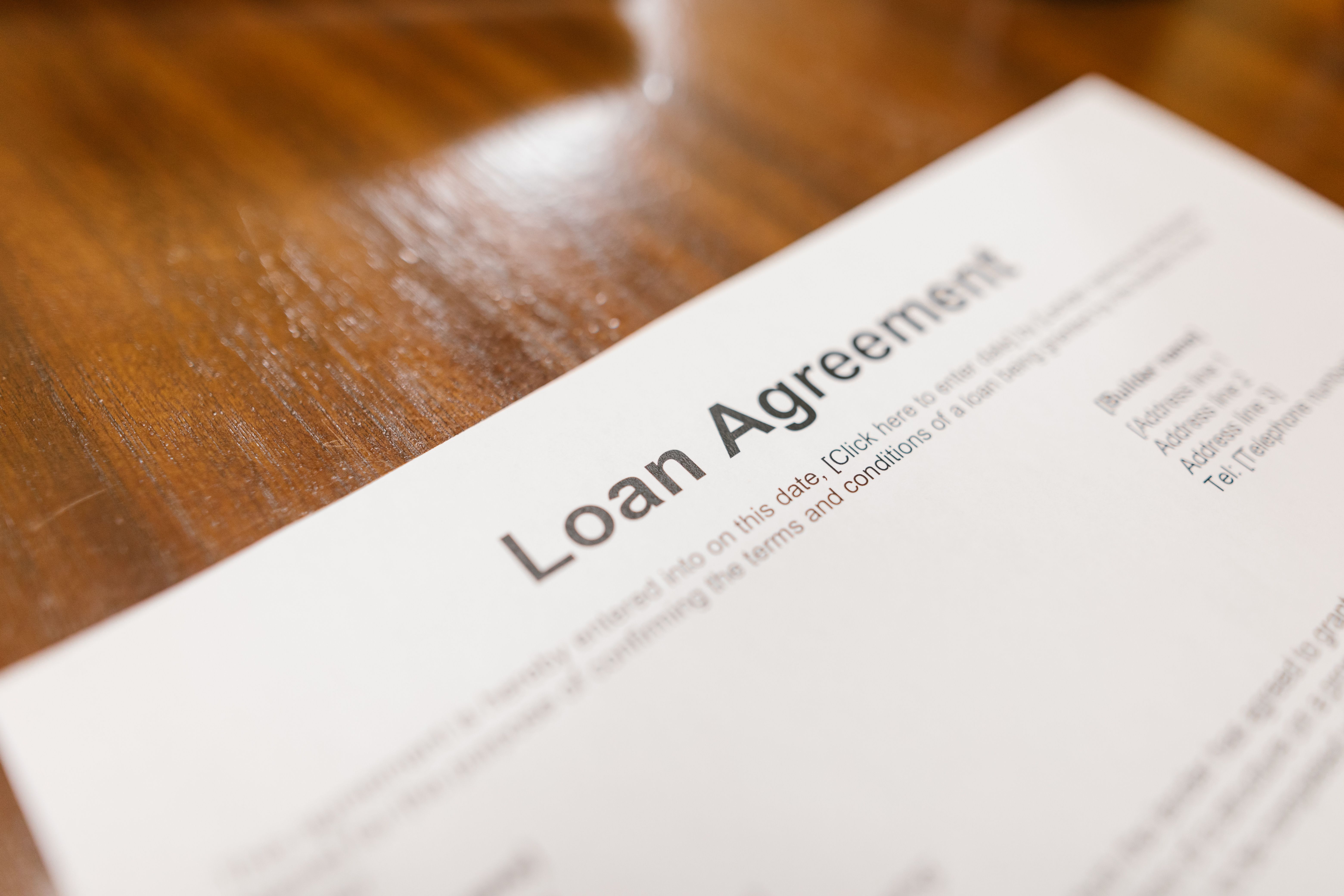 a loan agreement on a wooden table