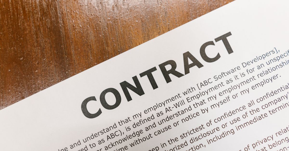 Photo by RDNE Stock project A detailed close-up of a printed contract document on a wooden table surface.