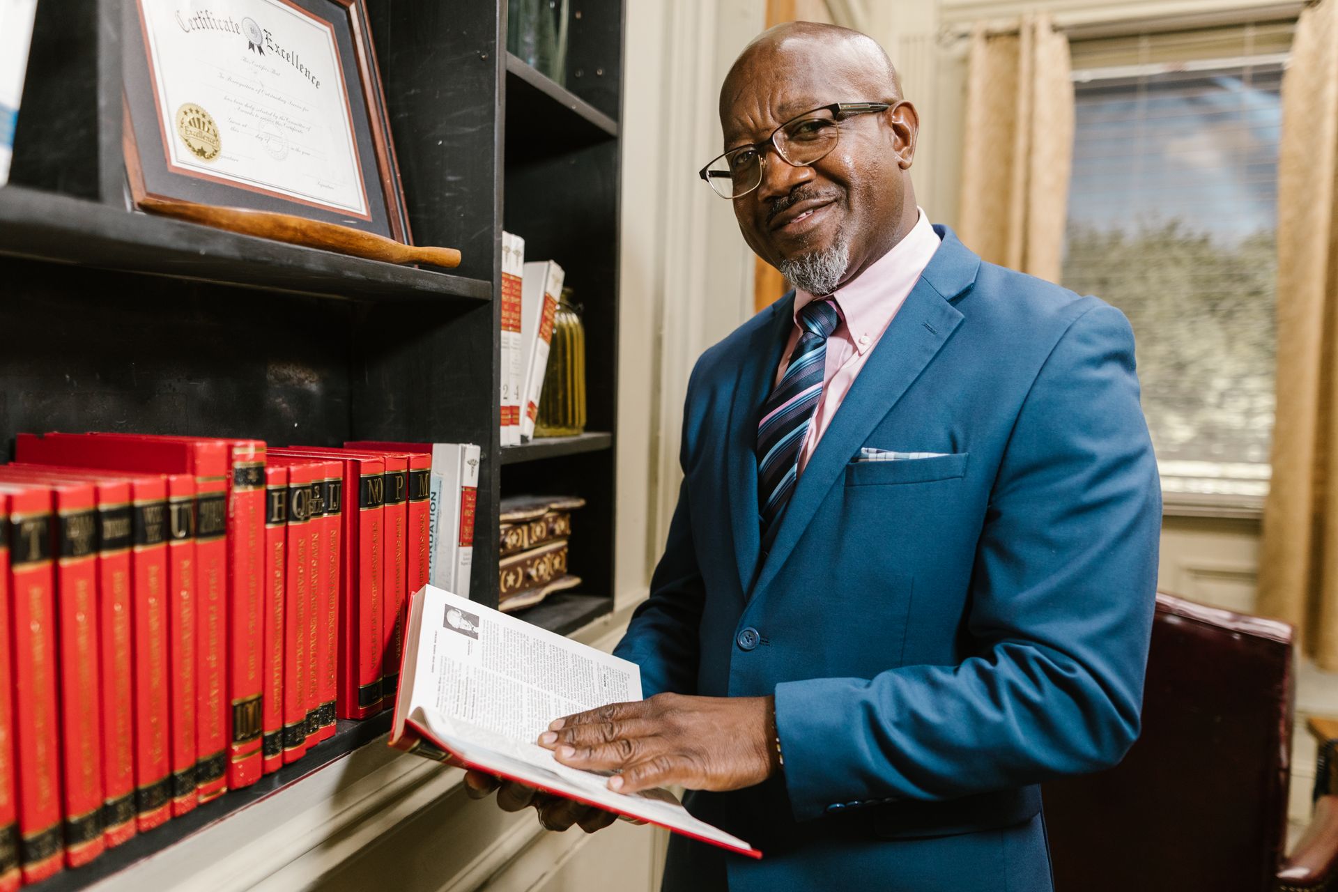 A partner at the firm's library, reviewing a bound report