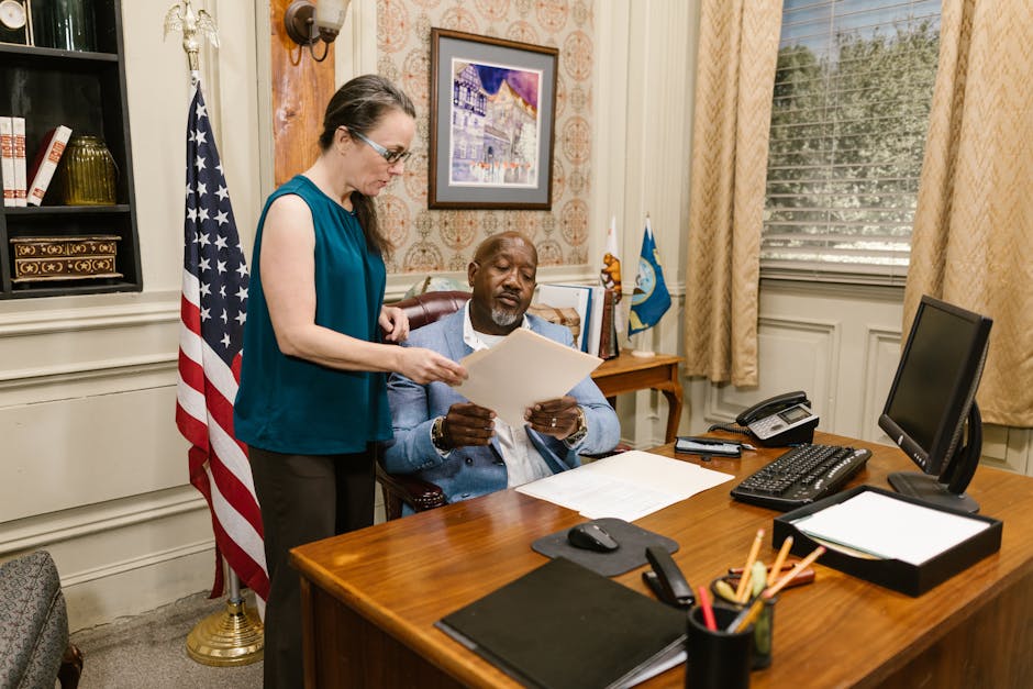 Immigration attorney reviewing documents with client - Columbus immigration lawyer Immigration attorney reviewing documents with client - Columbus immigration lawyer