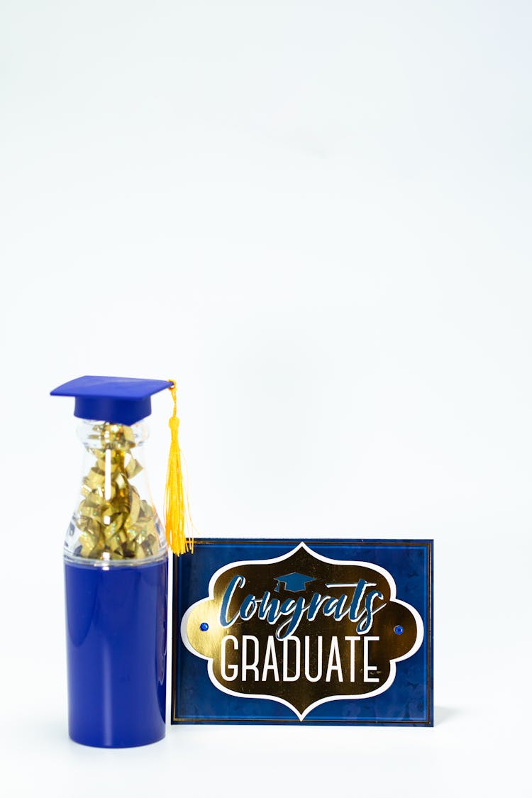 A Graduation Greeting Card With Tumbler