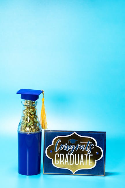 Vertical shot of a graduation cap and congrats sign on a vibrant blue background.
