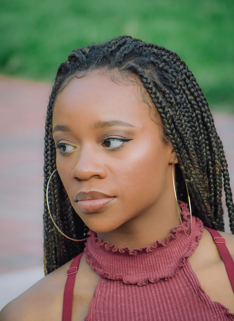 Woman with braided hair and colorful rubber bands