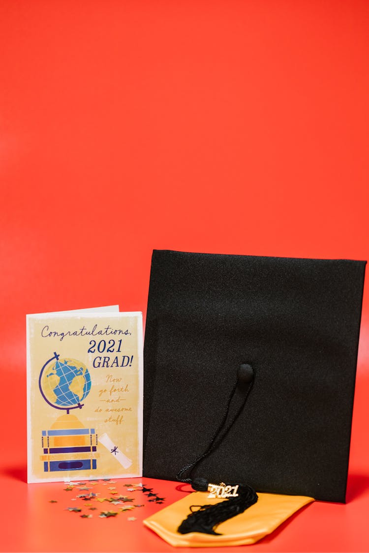 A Square Academic Cap Beside A Graduation Greeting Card