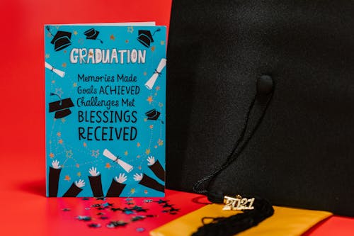 Free Blue Card with Quote Beside Graduation Cap Stock Photo