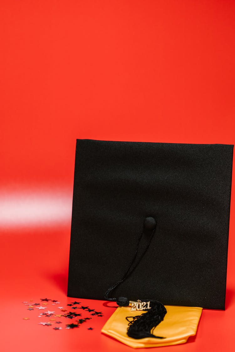 Graduation Cap On Red Background