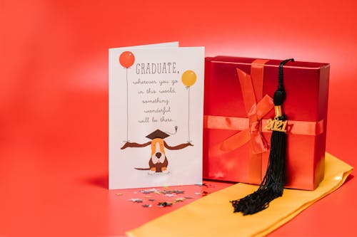 Greeting Card Beside Red Gift Box on Yellow Tie