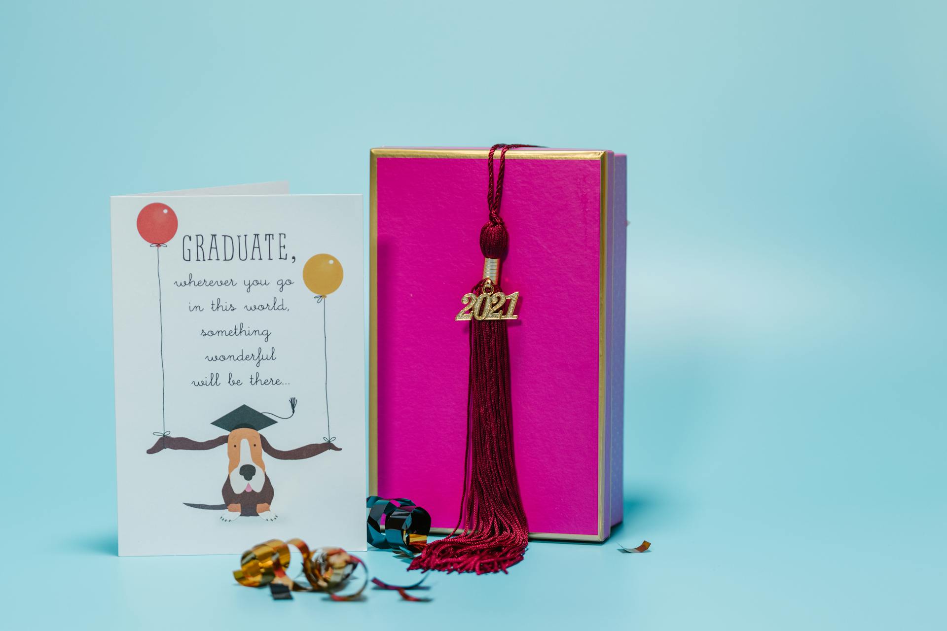 Graduation Gift and Card on Blue Background