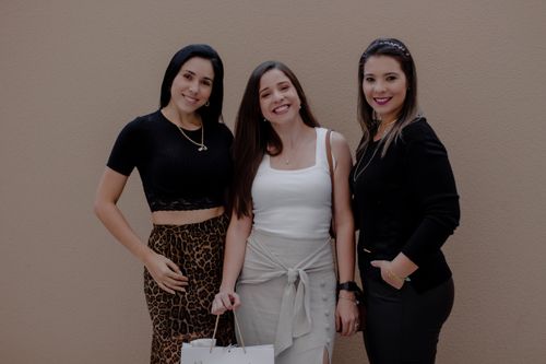 Free Three fashionable women posing together with shopping bags, exuding confidence and style. Stock Photo