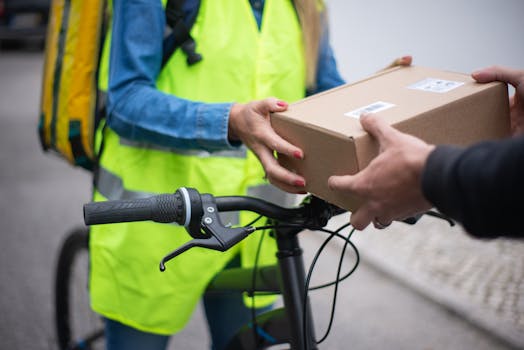 Bicycle courier handing over a package outdoors in Portugal.